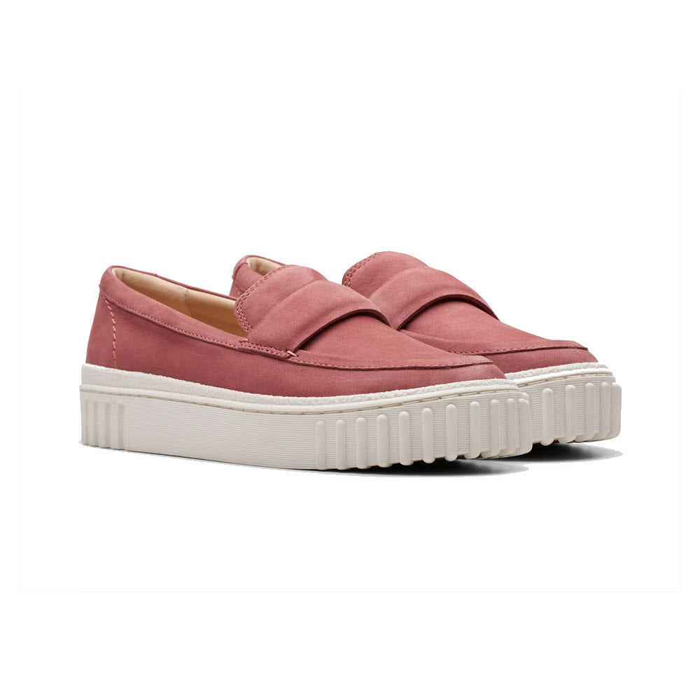 A pair of Clarks Mayhill Cove dusty rose nubuck slip-on shoes with chunky white soles and wide overlapping straps on the upper.
