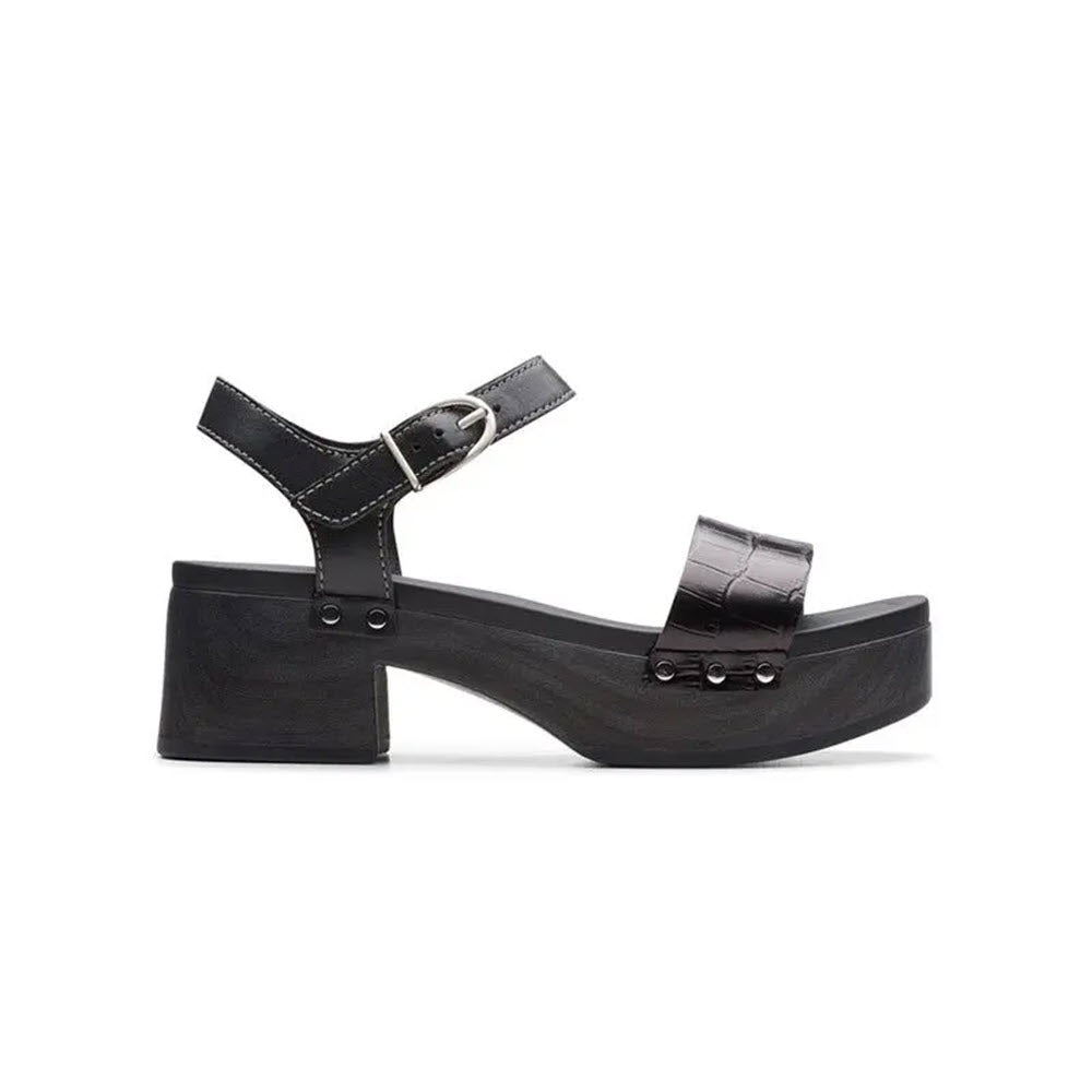 Black platform sandal crafted from butter-soft black leather, featuring a chunky heel and a buckle strap, isolated on a white background. - CLARKS SIVANNE BAY BLACK - WOMENS by Clarks