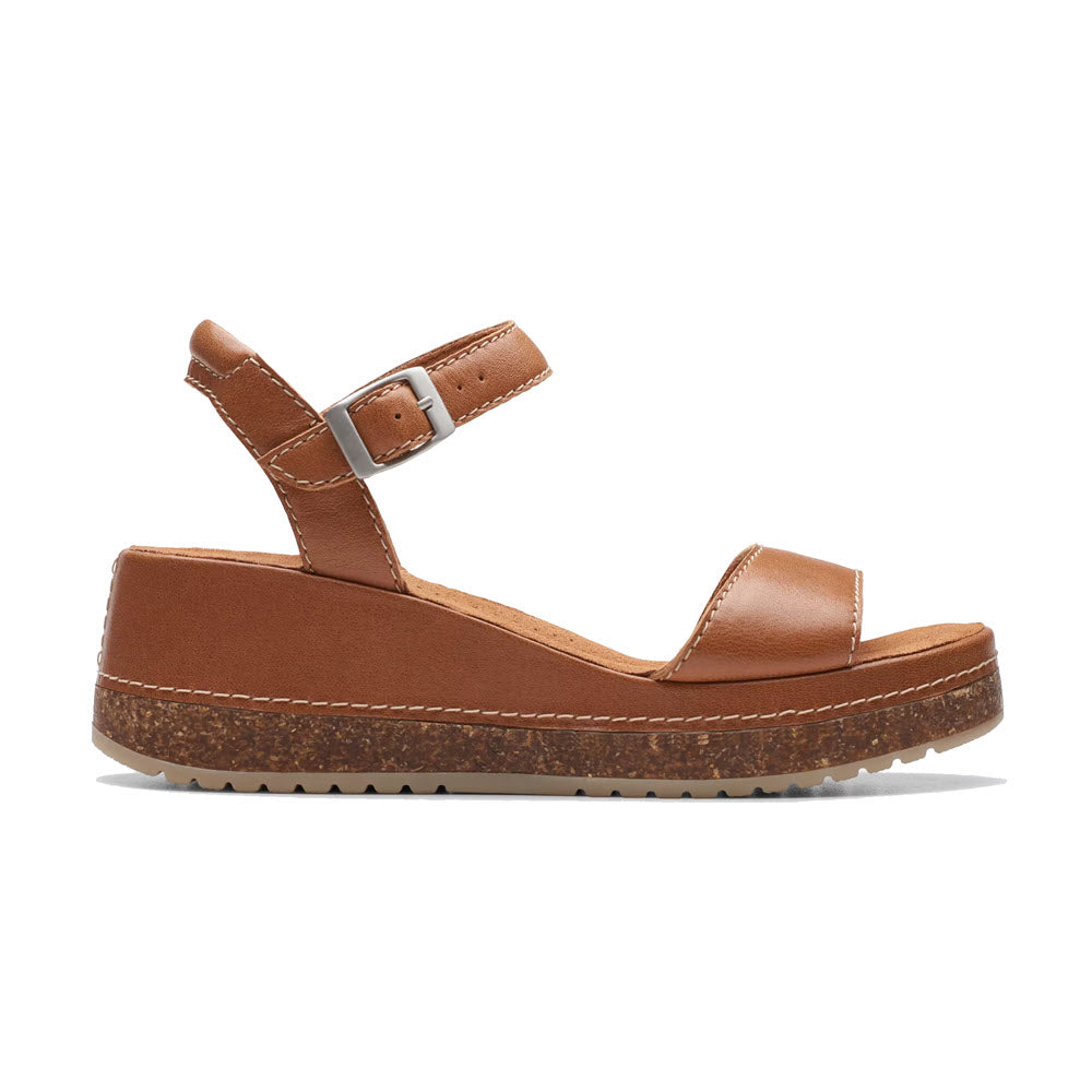 Brown leather platform sandal with a buckle strap and cork-effect wedge heel, isolated on a white background, Clarks Kassanda Lily Tan - Womens.