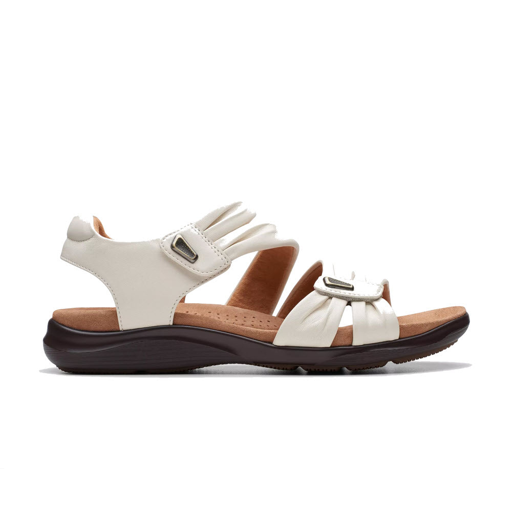 White casual Clarks Kitly Ave sandals with adjustable straps and a low heel.