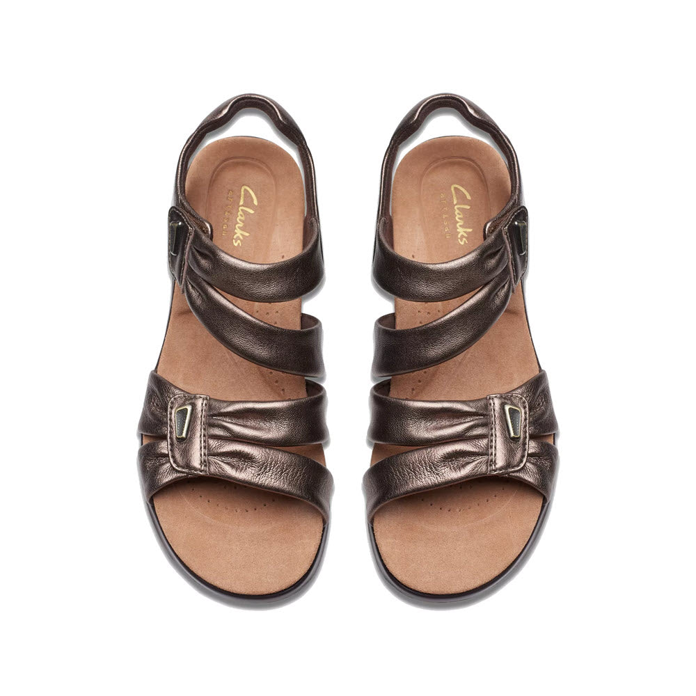 A pair of Clarks Kitly Ave Bronze open-toe sandals displayed on a white background.