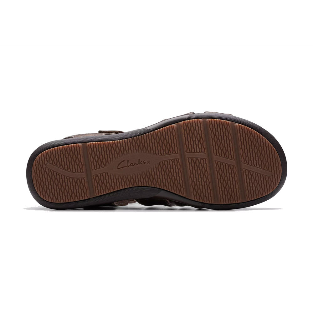 Sole of a Clarks Kitly Ave Bronze sandal displaying the brand&#39;s textured tread pattern and logo.