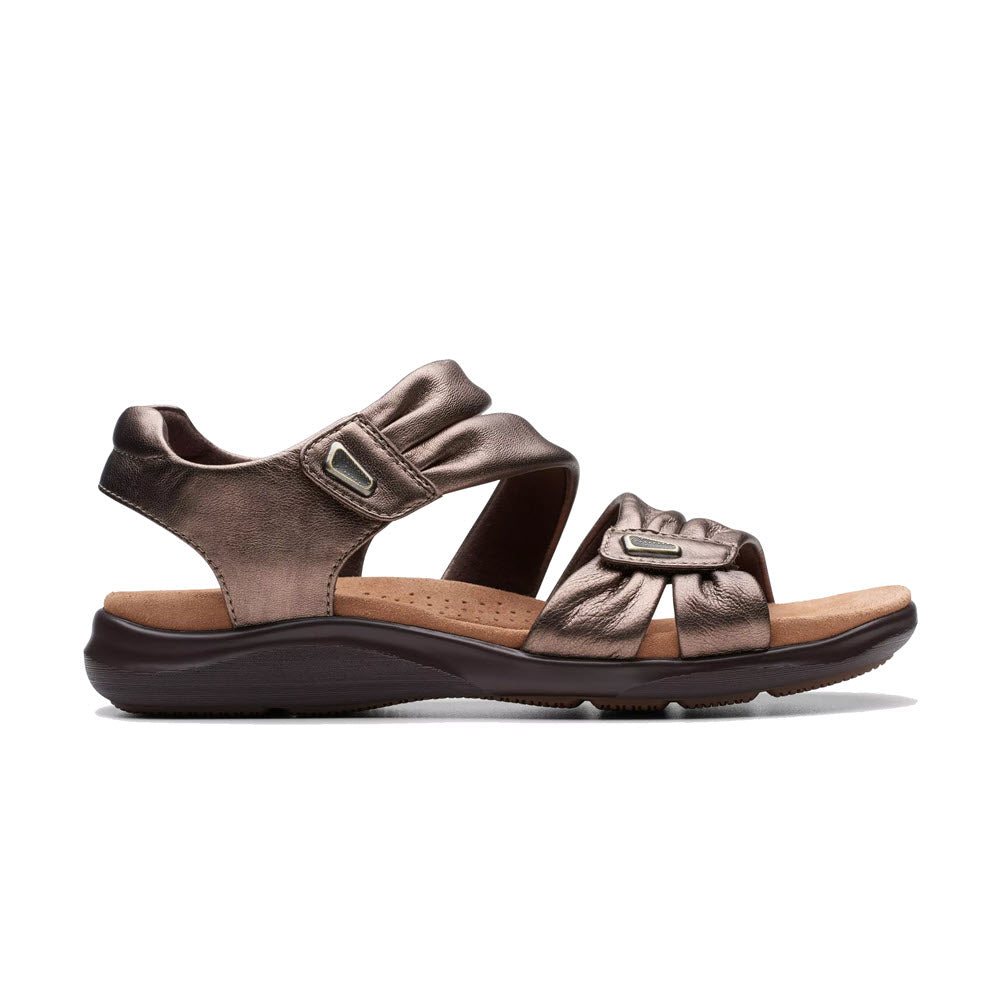 A single brown leather Clarks Kitly Ave sandal with an adjustable buckle strap and a contour cushion footbed.