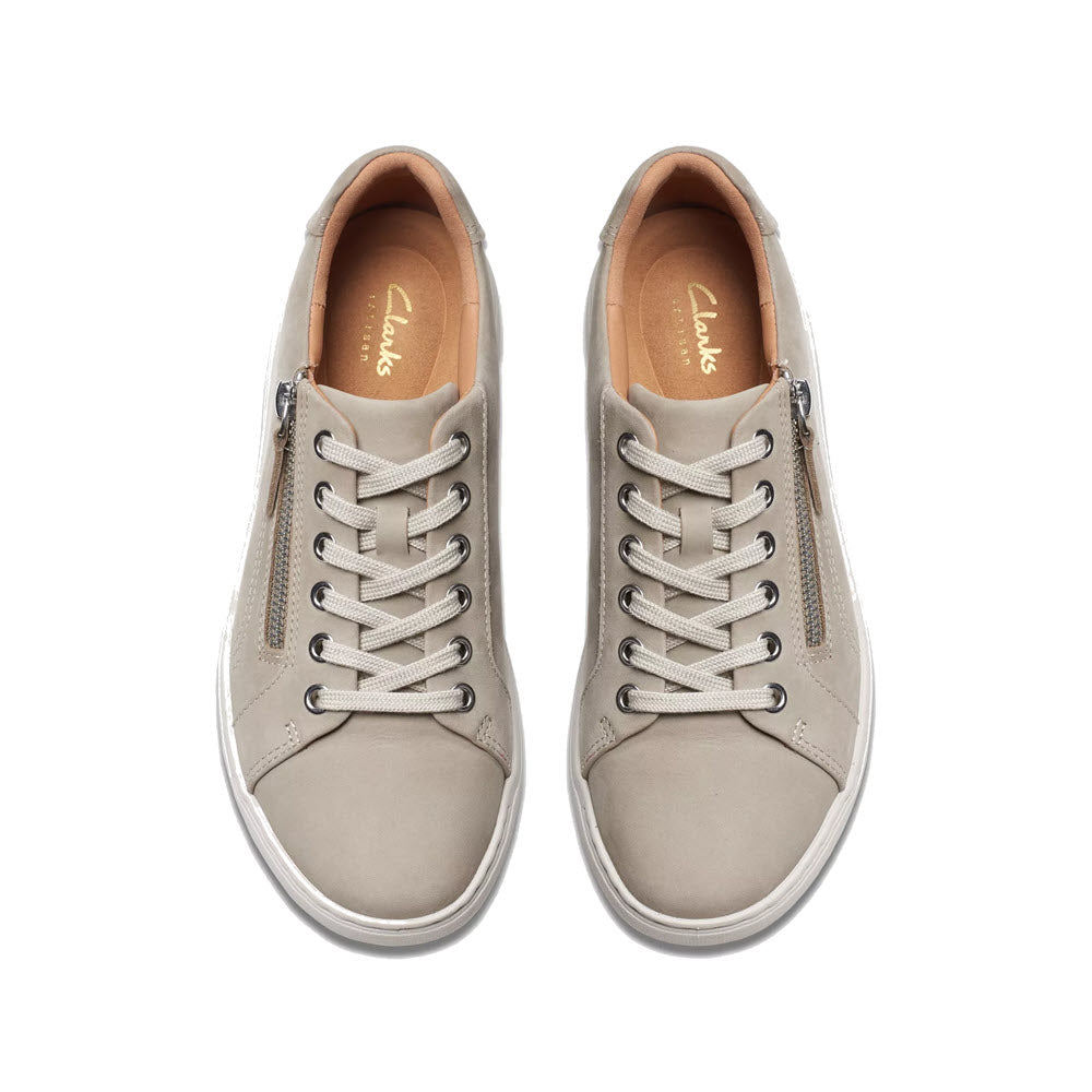 A pair of light gray Clarks brand Nalle Lace Stone sneakers with laces, viewed from above on a white background.
