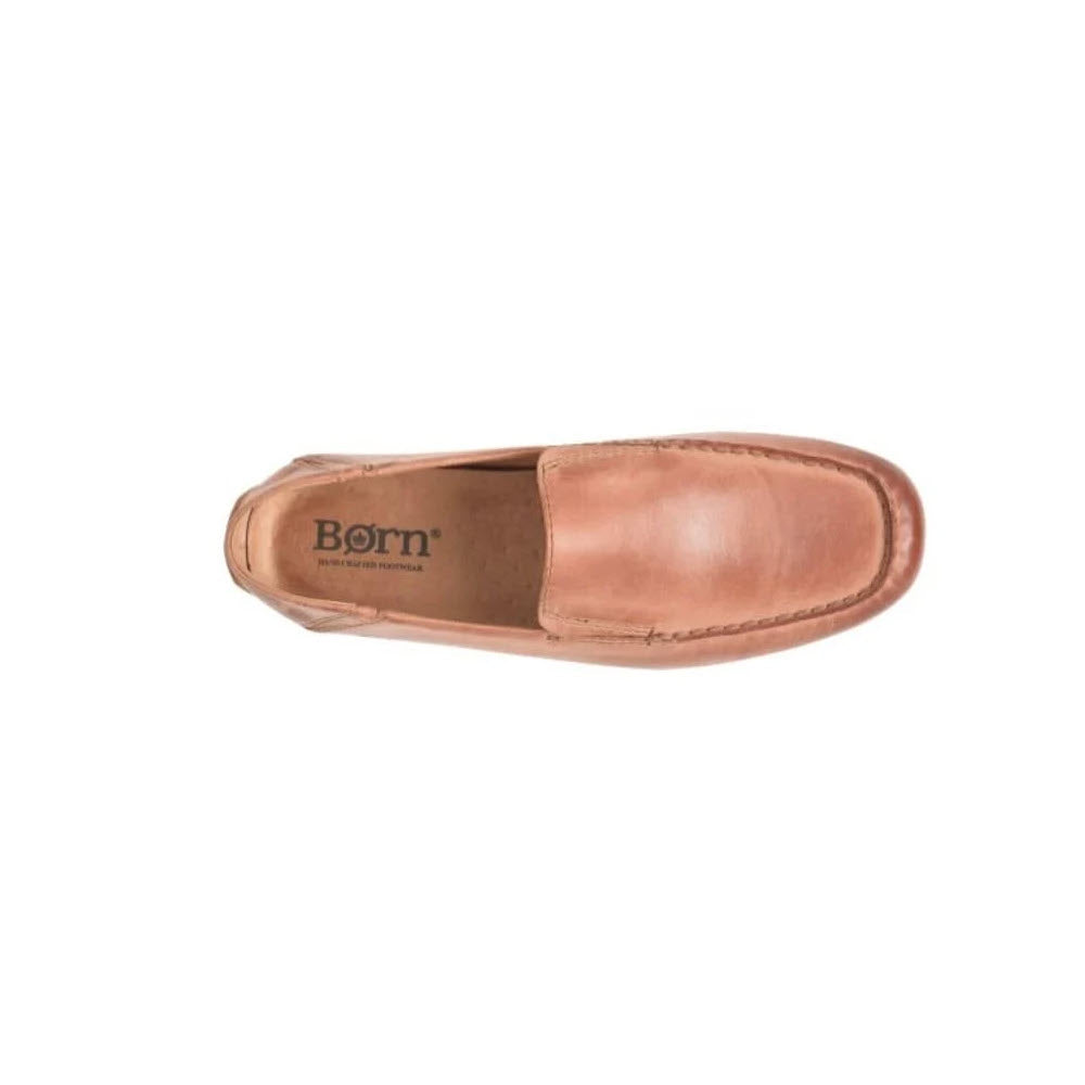 Top view of a single Born Marcel slip-on driving moc cognac shoe with visible stitching and the brand &quot;born&quot; on the moisture-wicking lining.