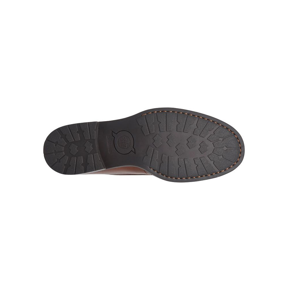 Black rubber outsole of a Born shoe displaying a complex tread pattern and a visible brand logo in the center.