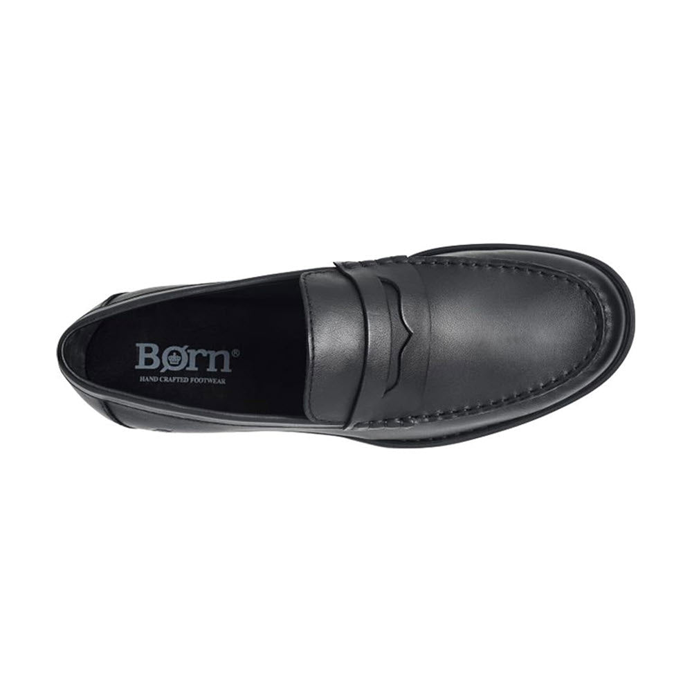 Top view of a single Born Matthew slip-on penny loafer in black leather with a logo visible on the insole.