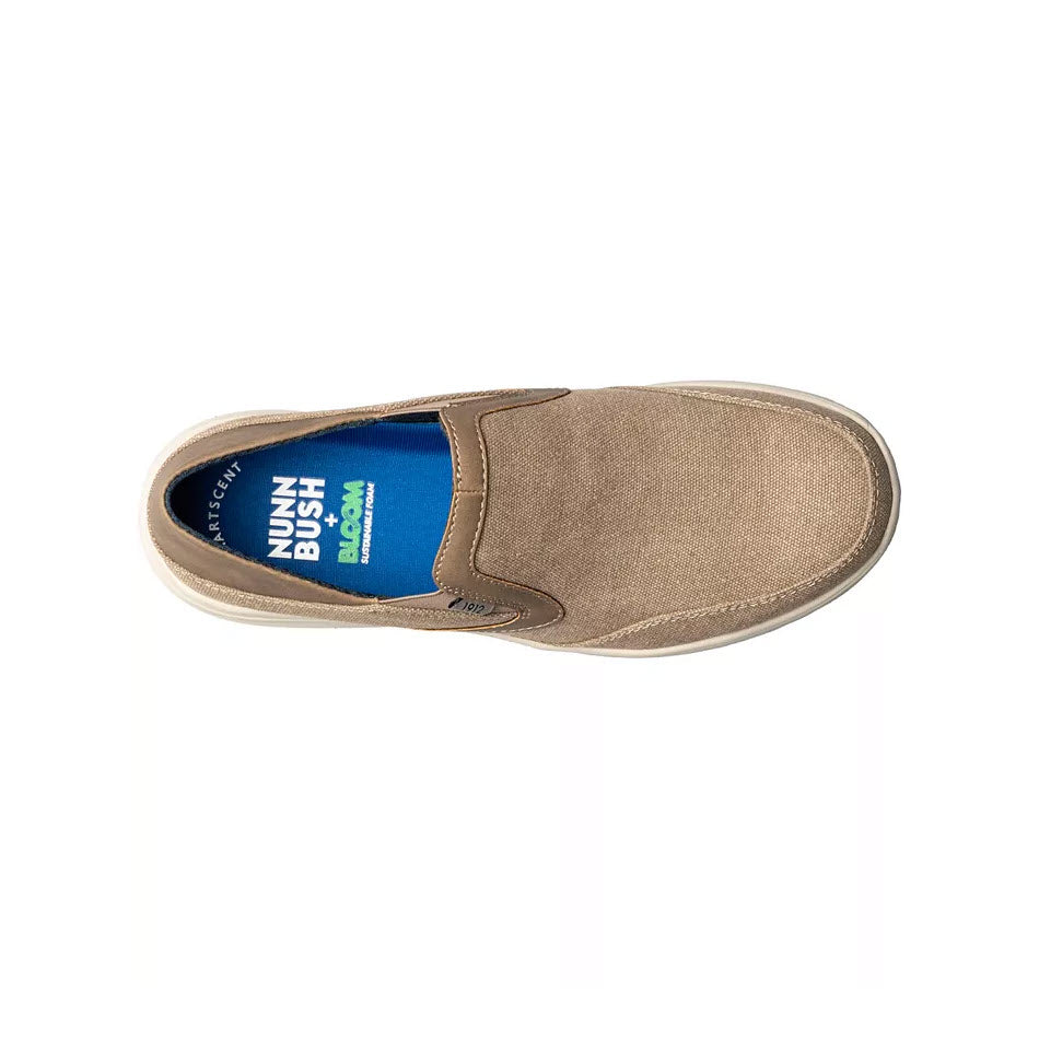 A single beige NUNN BUSH CONWAY EZ canvas moc toe slip-on shoe with a blue inner lining and &quot;Nunn Bush Conway&quot; text, viewed from the top on a white background.