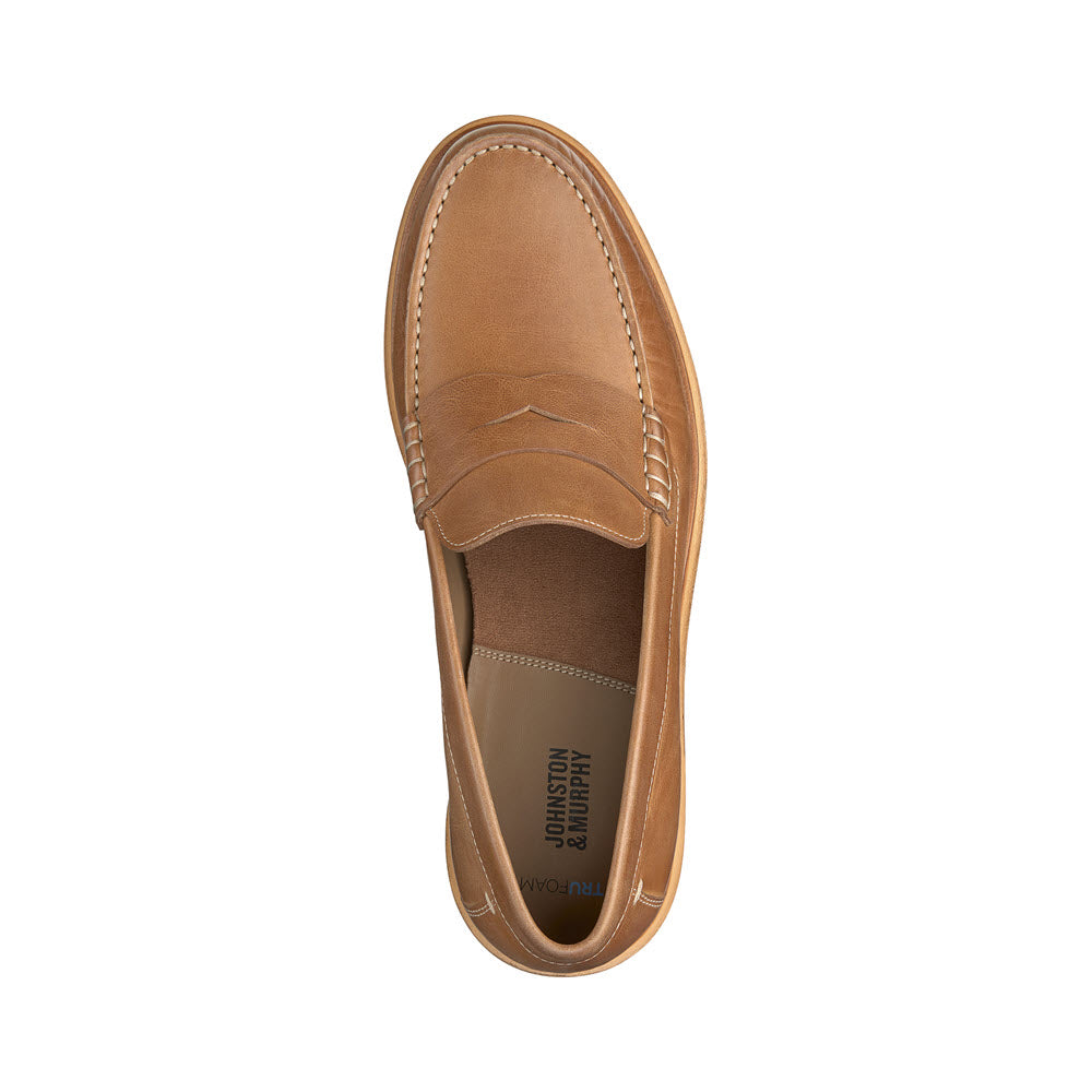Top view of a Johnston &amp; Murphy Lyles Slip On Penny Tan Full Grain - Mens loafer with moc toe stitching and visible brand imprint on the insole.