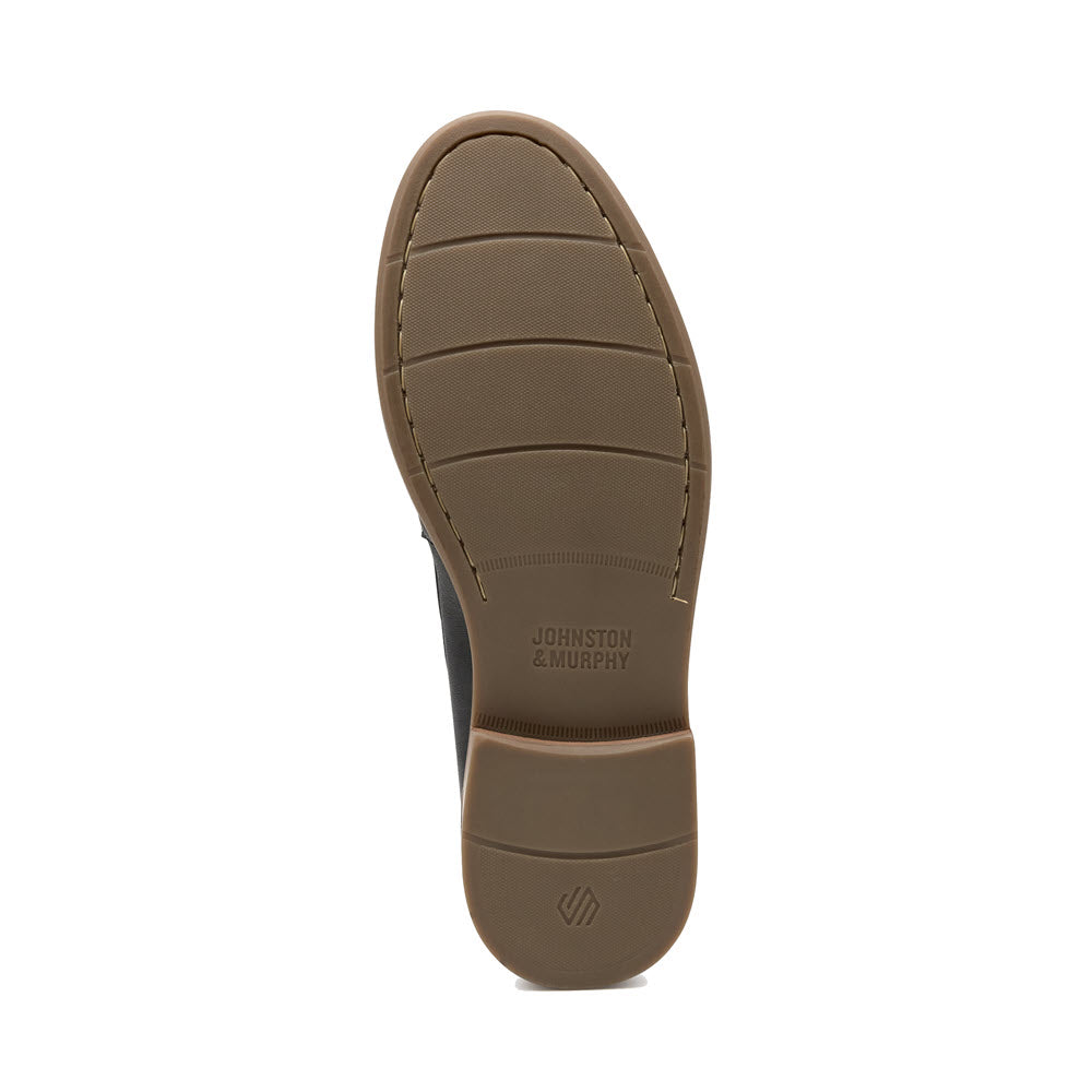 Bottom view of a brown Johnston &amp; Murphy Lyles Slip On Penny Tan Full Grain - Mens moc toe shoe showing the tread pattern and brand name on the sole.
