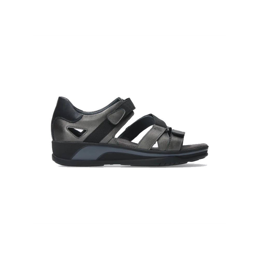 A black Wolky Nomad Inox orthopedic sandal with supportive straps and a thick sole, isolated on a white background.