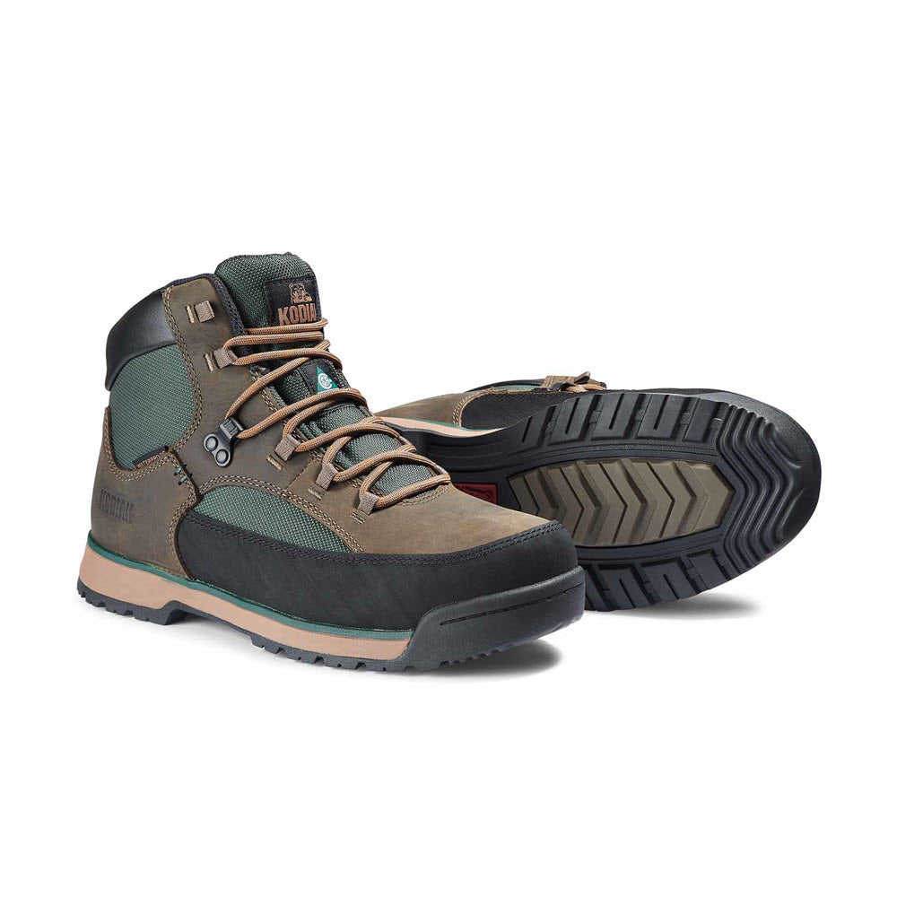 A pair of Kodiak ST GREB Classic Hike Waterproof Work Boots in green and brown waterproof leather, showing both the side view and the sole.