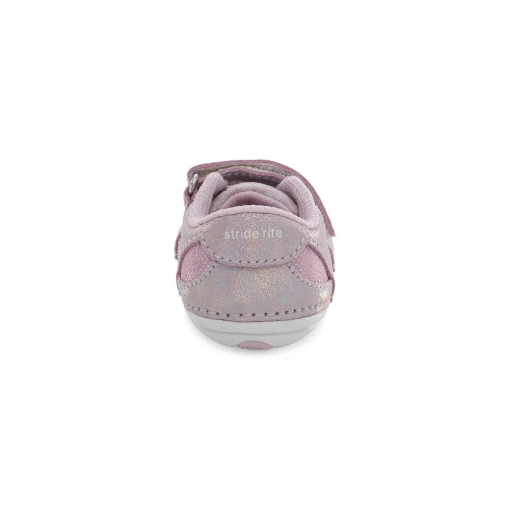 Rear view of a single purple Stride Rite toddler&#39;s shoe with velcro strap and memory foam sole on a white background.