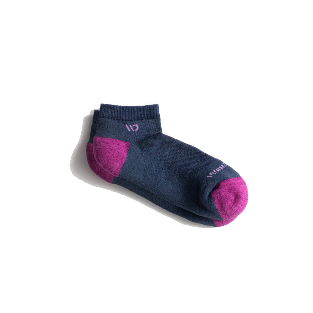 The Wide Open "Wide Open No Show Socks Cushion Denim - Women's" features a single dark blue ankle sock with purple accents on the toe and heel, and Comfort Stitch Cushioning, viewed against a white background.