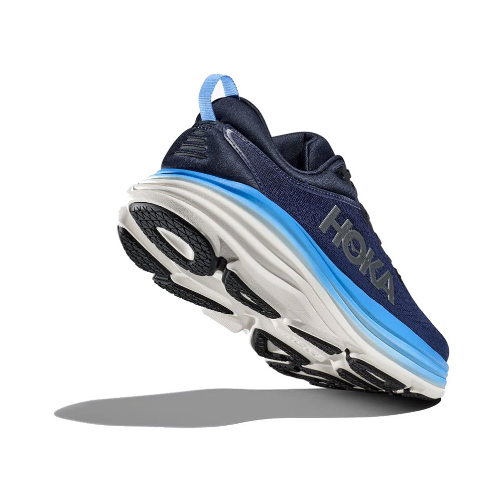 An ultra-cushioned HOKA BONDI 8 OUTER SPACE/ALL ABOARD running shoe with a blue upper and white sole, featuring blue accents and black tread, floating against a white background.