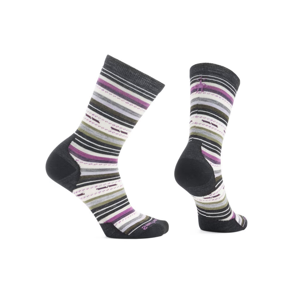 Two multicolored striped socks featuring horizontal lines in various shades of gray, white, purple, and green displayed from the side and back views. These Smartwool Margarita Crew Socks in White/Black for women are crafted from premium Merino wool and feature Shred Shield technology for enhanced durability.