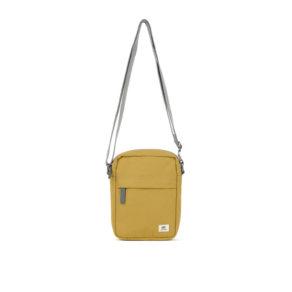 A small ORI LONDON BOND A CROSSBODY FLAX bag with a silver chain strap and a front zipper pocket, displayed against a white background. This lightweight urban accessory fits mobile phones comfortably.