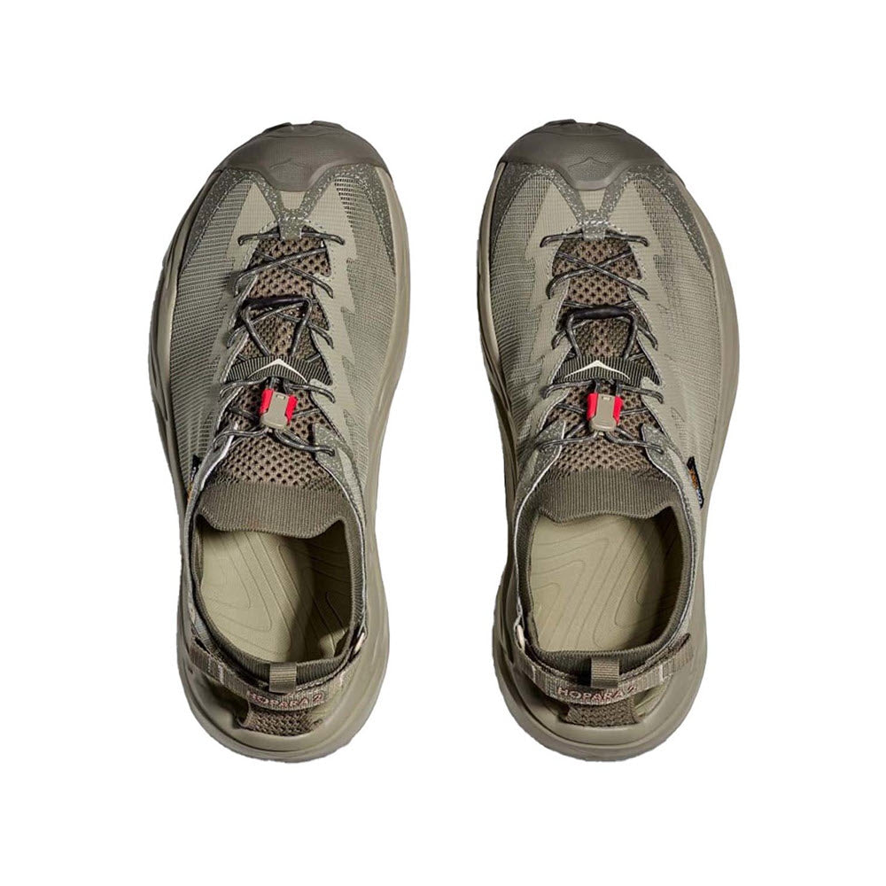 A pair of HOKA HOPARA 2 BARLEY/OAT MILK - MENS hiking sandals in olive green with laces untied, viewed from above.