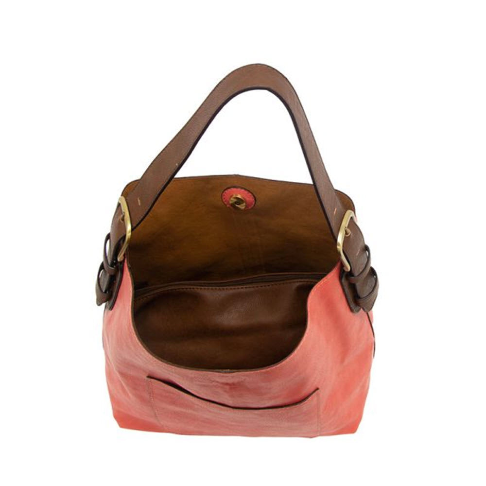 A brown and coral JOY SUSAN HOBO BAG LIVING CORAL with a single brown strap, metallic buckles, and a round clasp, positioned against a white background.