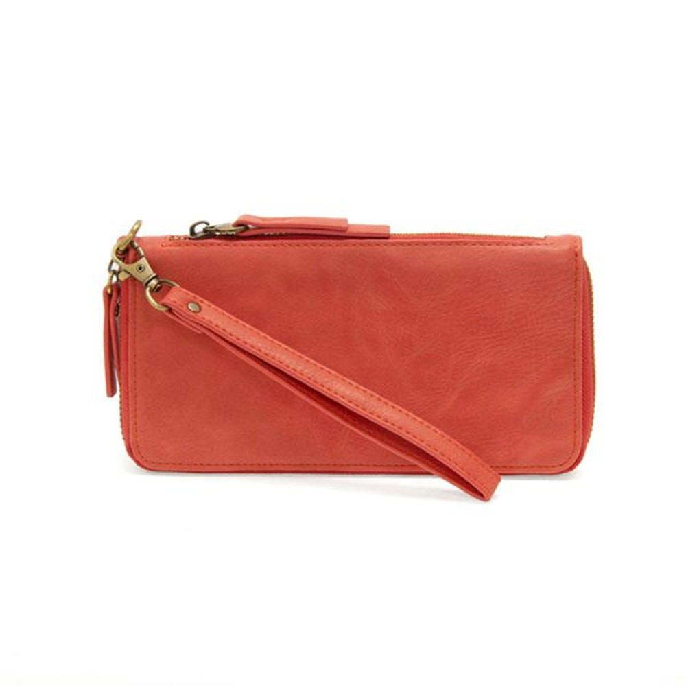JOY SUSAN CHLOE WALLET CORAL-colored vegan leather wristlet purse with a zipper and a detachable strap, isolated on a white background.