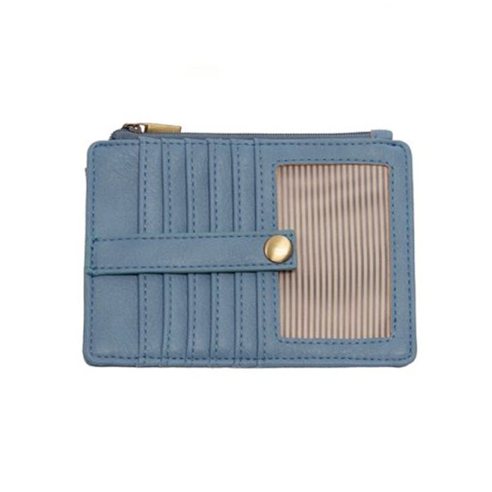 A JOY SUSAN PENNY MINI TRAVEL WALLET TRANQUIL BLUE in light blue with vertical stitching and a striped beige panel on the front, featuring a gold snap closure.