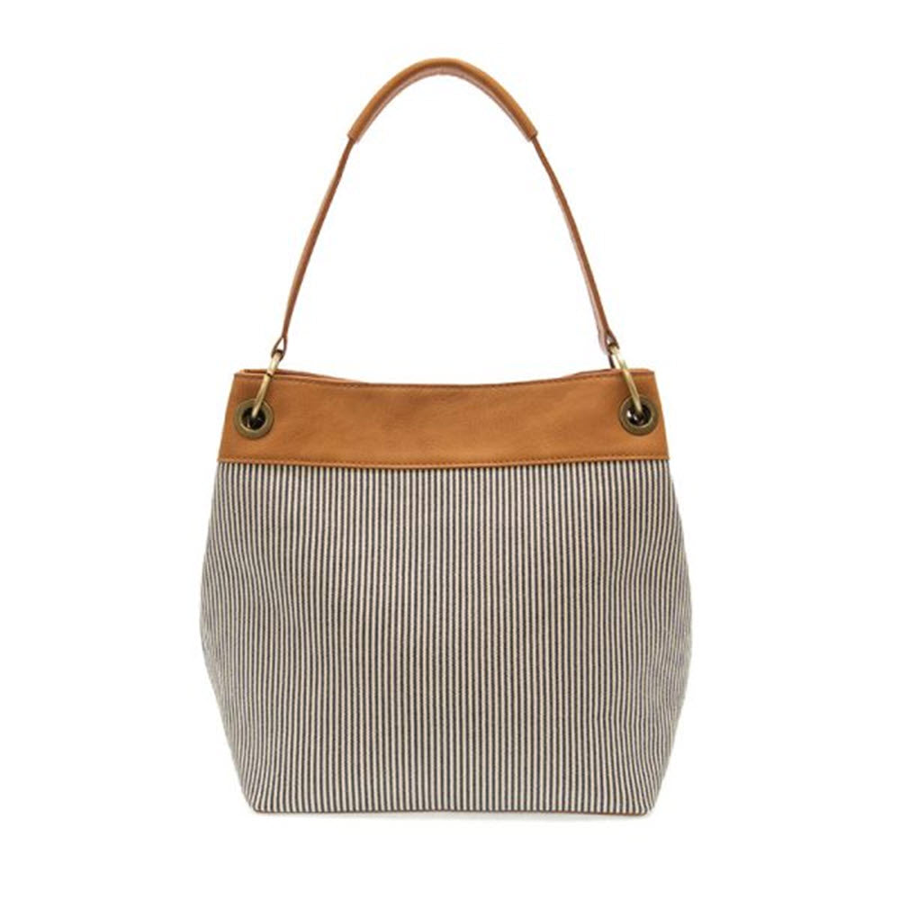 A JOY SUSAN LAUREL CANVAS SHOULDER DENIM PINSTRIPE tote bag with a tan vegan leather upper and handle, isolated on a white background.