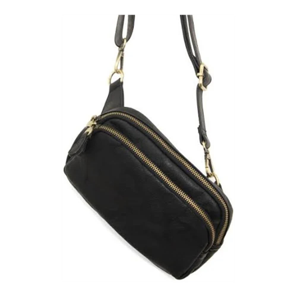 A black JOY SUSAN KYLIE BELT BAG with golden zippers, hanging against a white background.