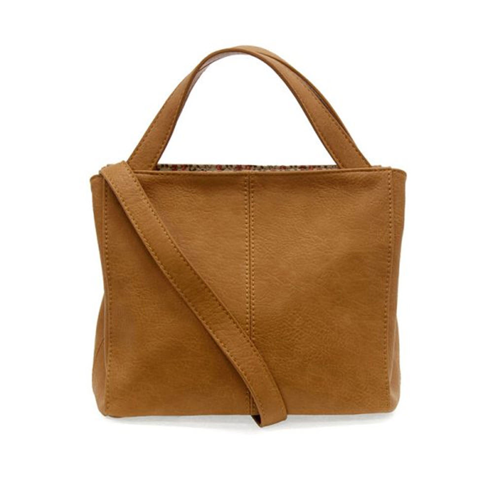 A JOY SUSAN BRANDI CROSSBODY MID TAN tote bag with a single crossbody strap and visible stitching, displayed against a white background.