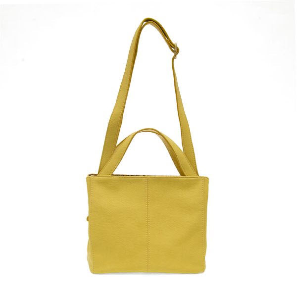 Joy Susan Brandi Crossbody Yellow vegan leather shoulder bag with adjustable strap against a white background.