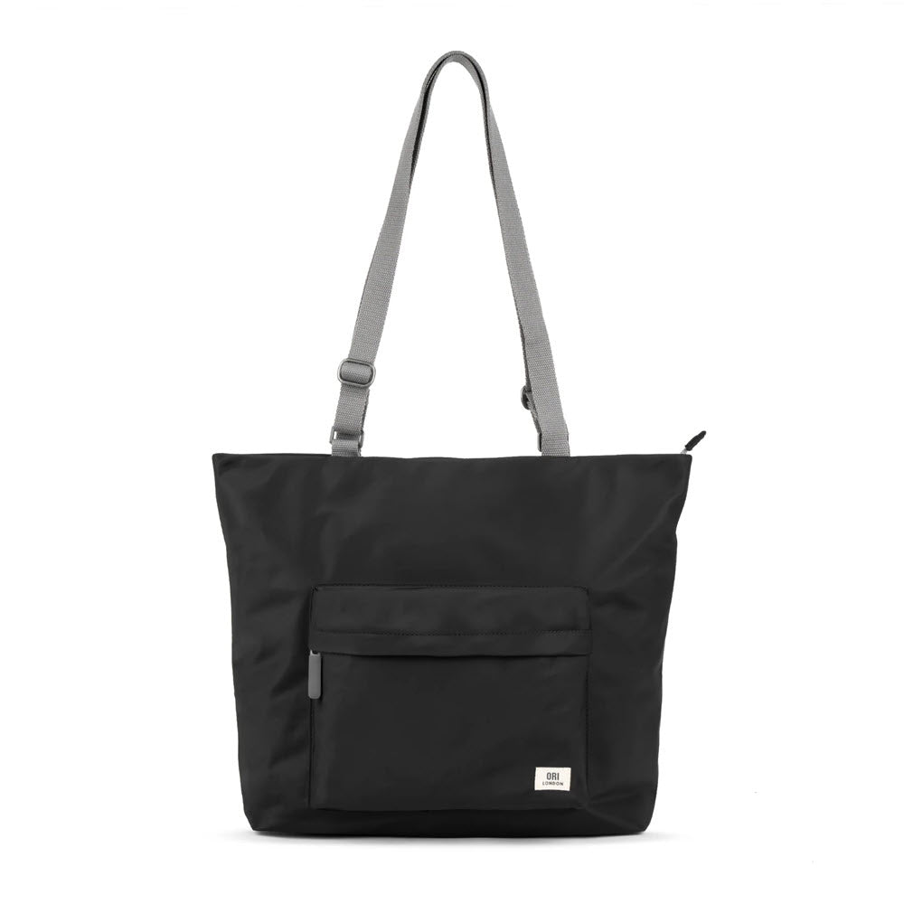 Ori London Trafalgar B tote in black with an adjustable gray strap and laptop pocket, displayed on a plain white background.