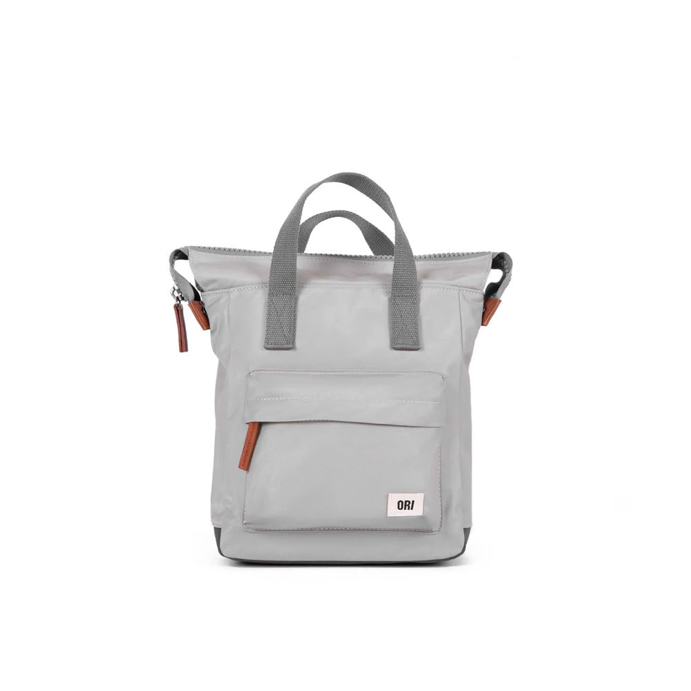 A light gray Ori London tote bag with top handles, a sturdy zip, and side pockets, displayed against a white background.