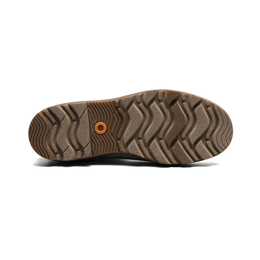 Bottom view of a shoe showing a brown rubber sole with a complex tread pattern and a single orange circular detail, featuring Bogs Rebound Cushioning.