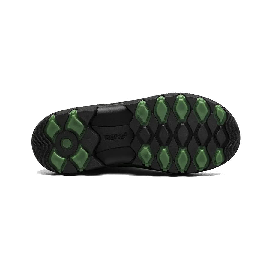 Sentence with updated product name and brand name: Black shoe sole with green hexagonal grip pads arranged in a geometric pattern, featuring a central &quot;boss&quot; logo and space-age seamless construction from Bogs Essential Rain Tall Grass - Kids.
