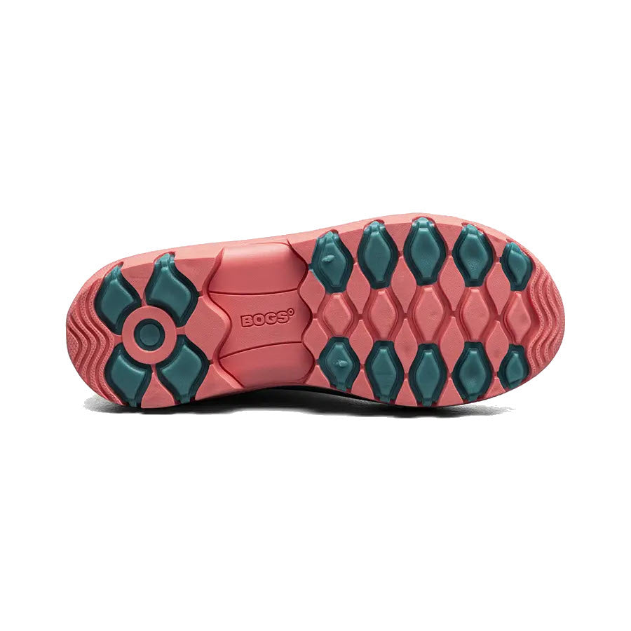 Bottom view of a BOGS ESSENTIAL RAIN TALL TURQUOISE - KIDS showcasing a tread pattern with hexagonal and diamond-shaped lugs in teal and pink, displaying the brand logo &quot;Bogs&quot;.