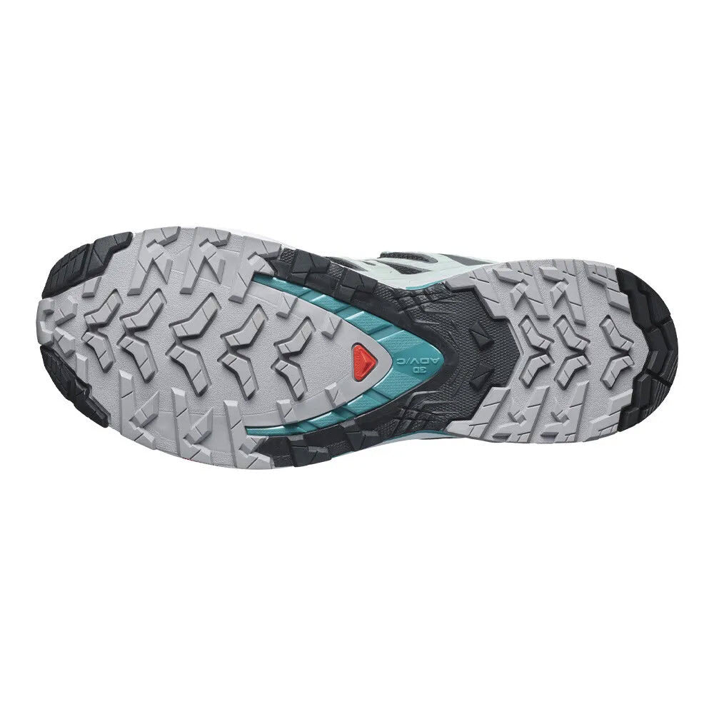 Bottom view of a gray Salomon XA PRO 3D V9 GTX trail running shoe sole with rugged tread pattern and a teal accent around the arch support.