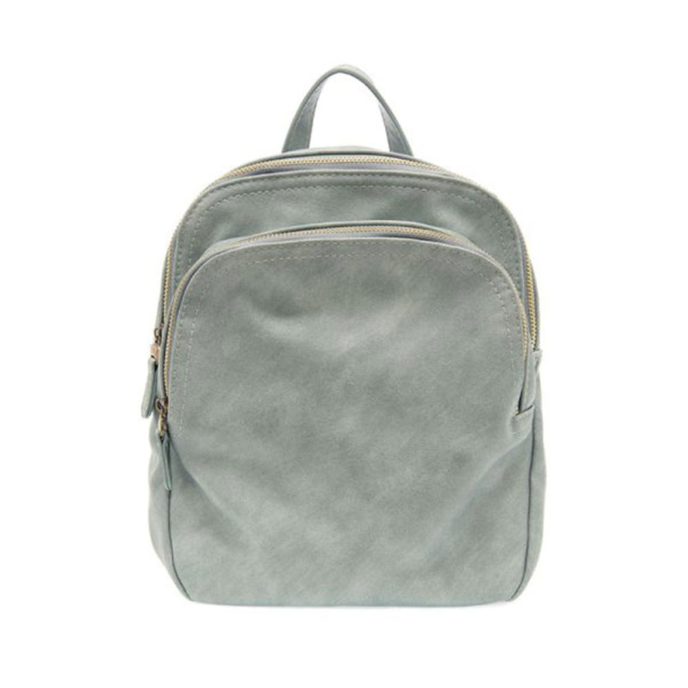 A light gray Joy Susan Frankie Backpack Aqua with a top handle and gold zippers, isolated on a white background.
