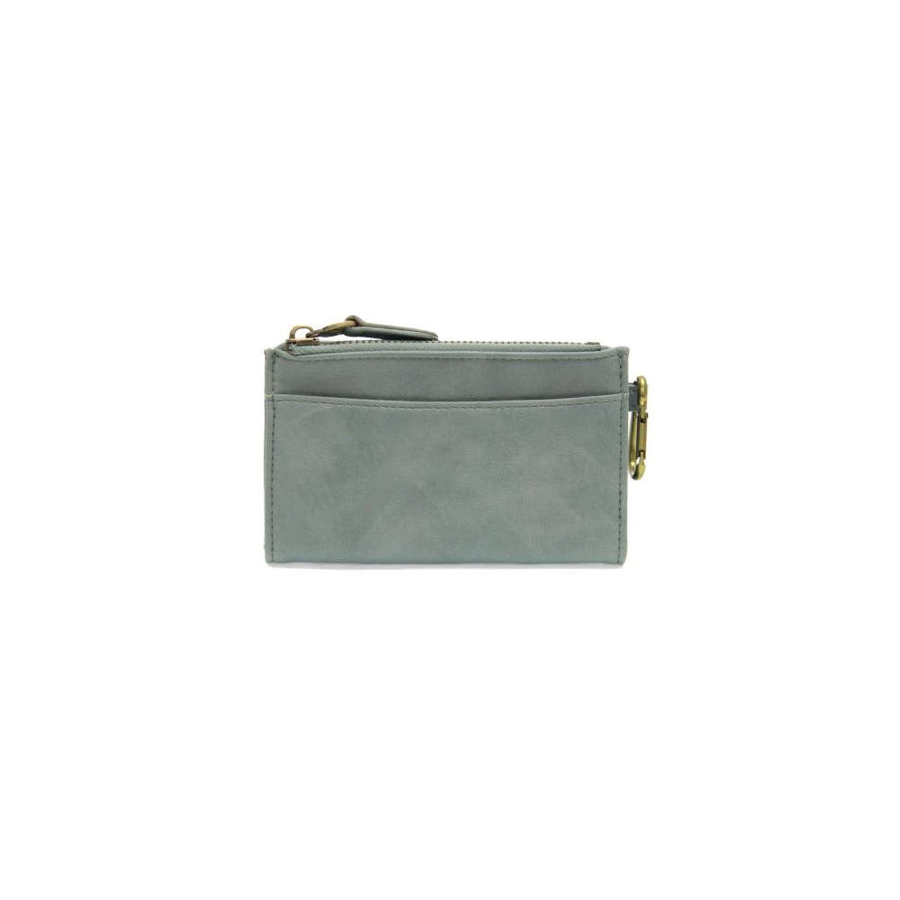 Joy Susan Bobbie Bifold Wallet Light Denim with a zippered compartment and external card slots, isolated on a white background.