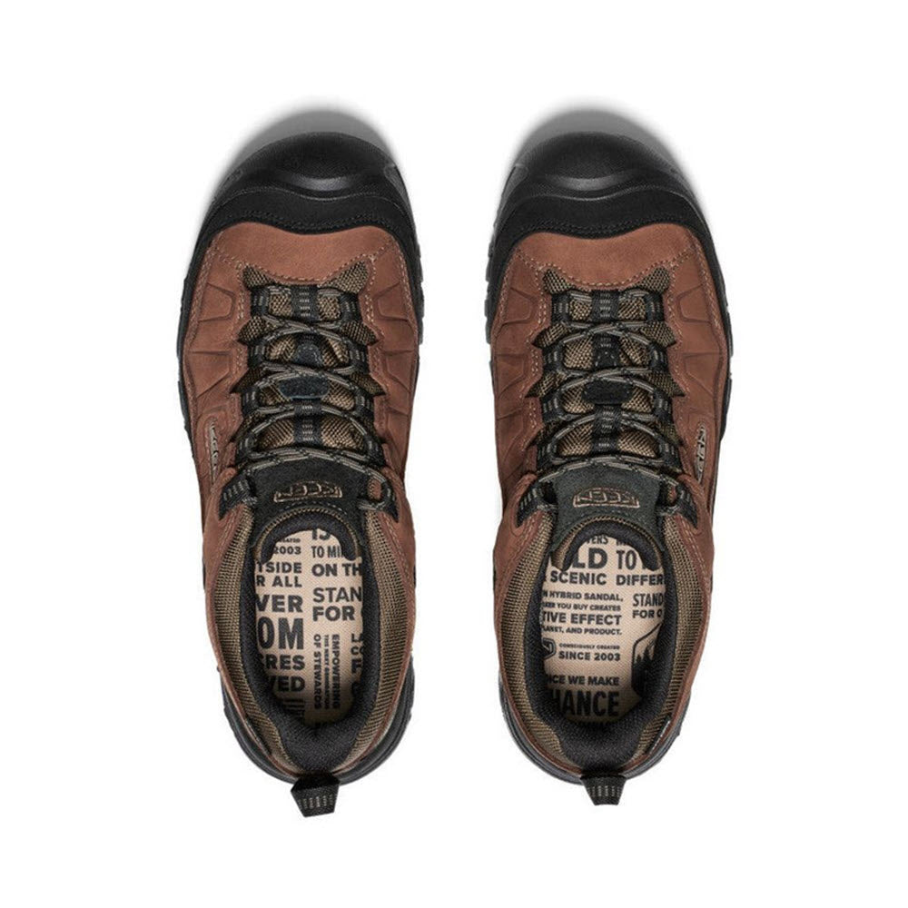 Top view of a pair of brown and black Keen Targhee IV WP Bison/Black hiking boots featuring durable Keen construction with detailed text and logos on the tongue.