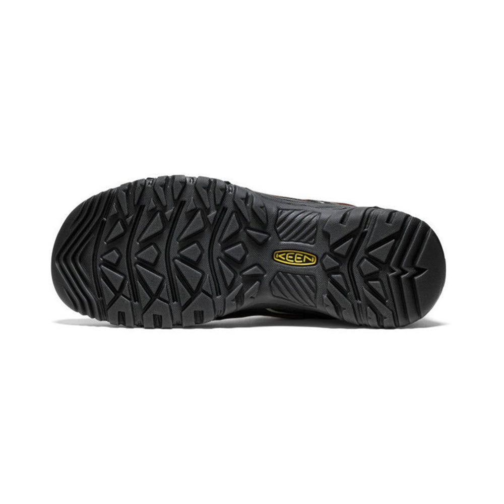 Sole of a black durable KEEN TARGHEE hiking shoe displaying deep tread patterns and the brand logo embossed in yellow.