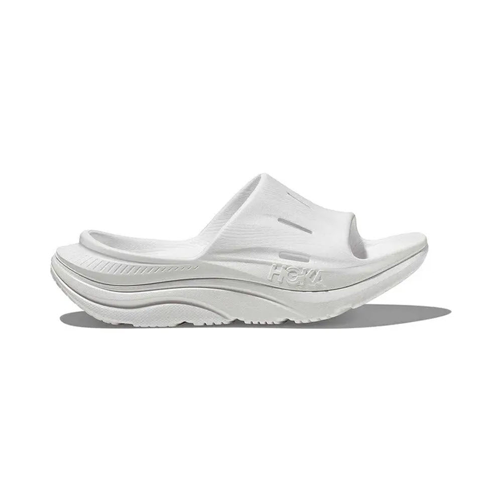 White Hoka Ora Recovery Slide 3 athletic sandal with a sugarcane footbed and thick sole, isolated on a white background.