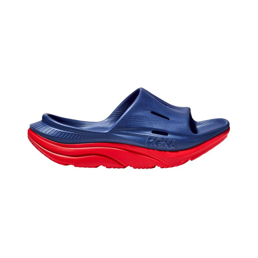 Blue and red HOKA ORA RECOVERY SLIDE 3 sandal isolated on a white background.