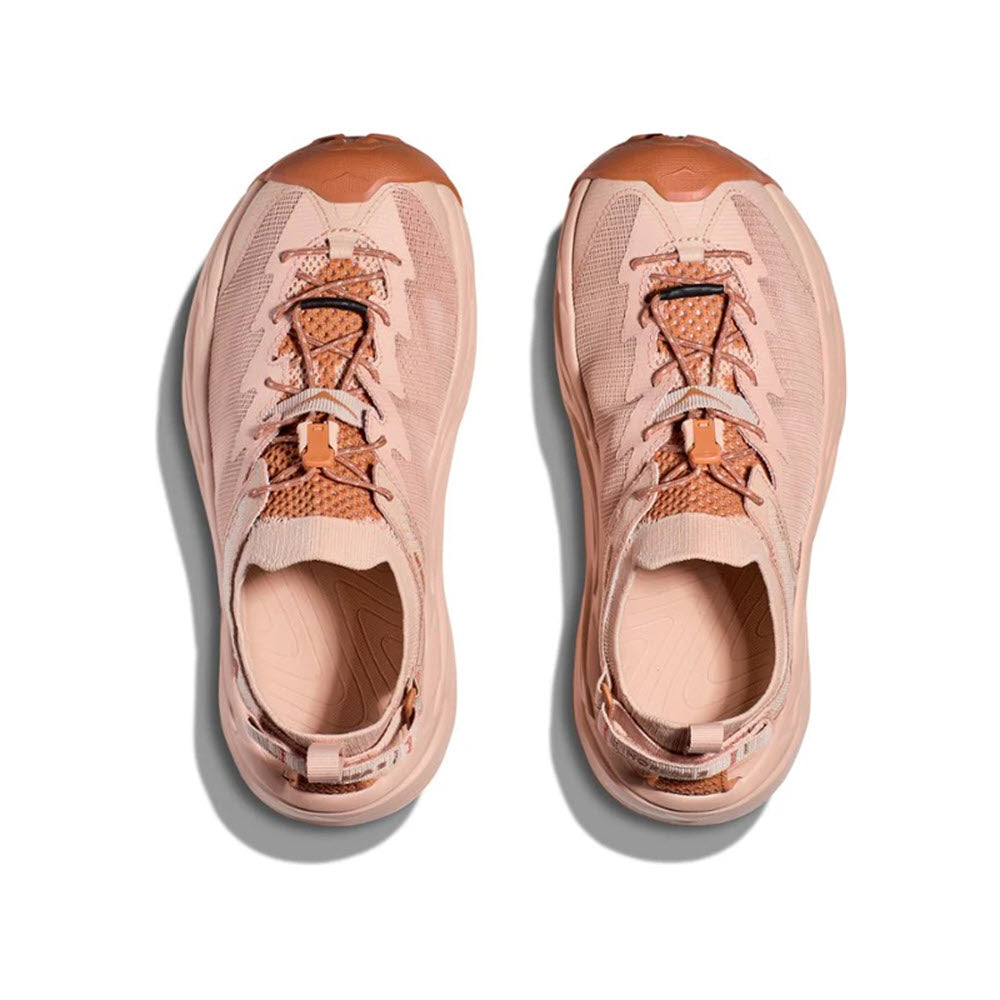 A pair of peach-colored Hoka Hopara 2 sandals viewed from above.