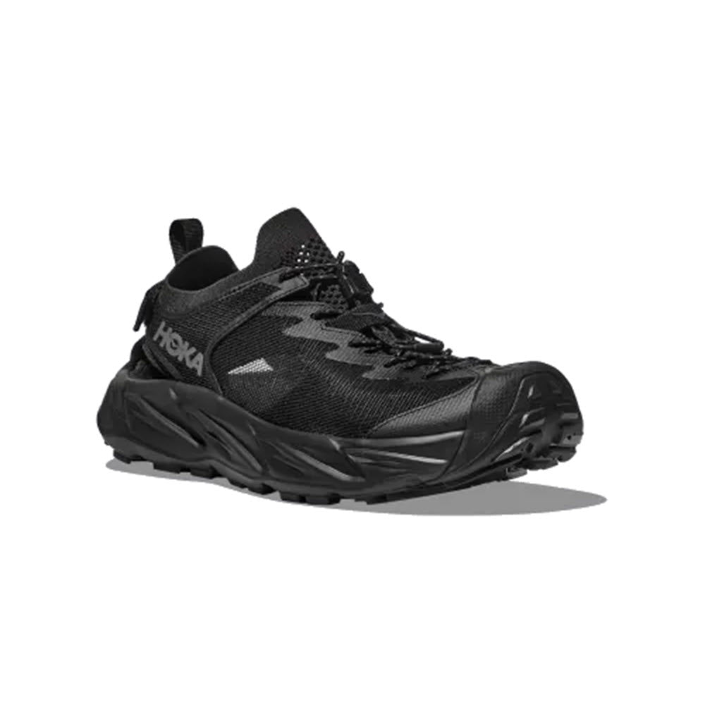 A single HOKA HOPARA 2 BLACK/BLACK - MENS shoe by Hoka, with a camouflage pattern on the side, made from recycled materials, displayed against a white background.