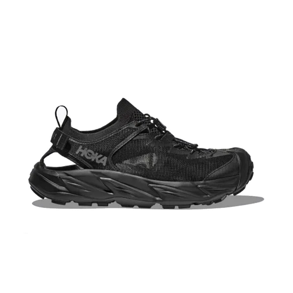 A HOKA HOPARA 2 black trail running shoe on a white background, featuring a thick, grooved sole and a fabric upper with quick-dry water repellency, including a visible brand logo.