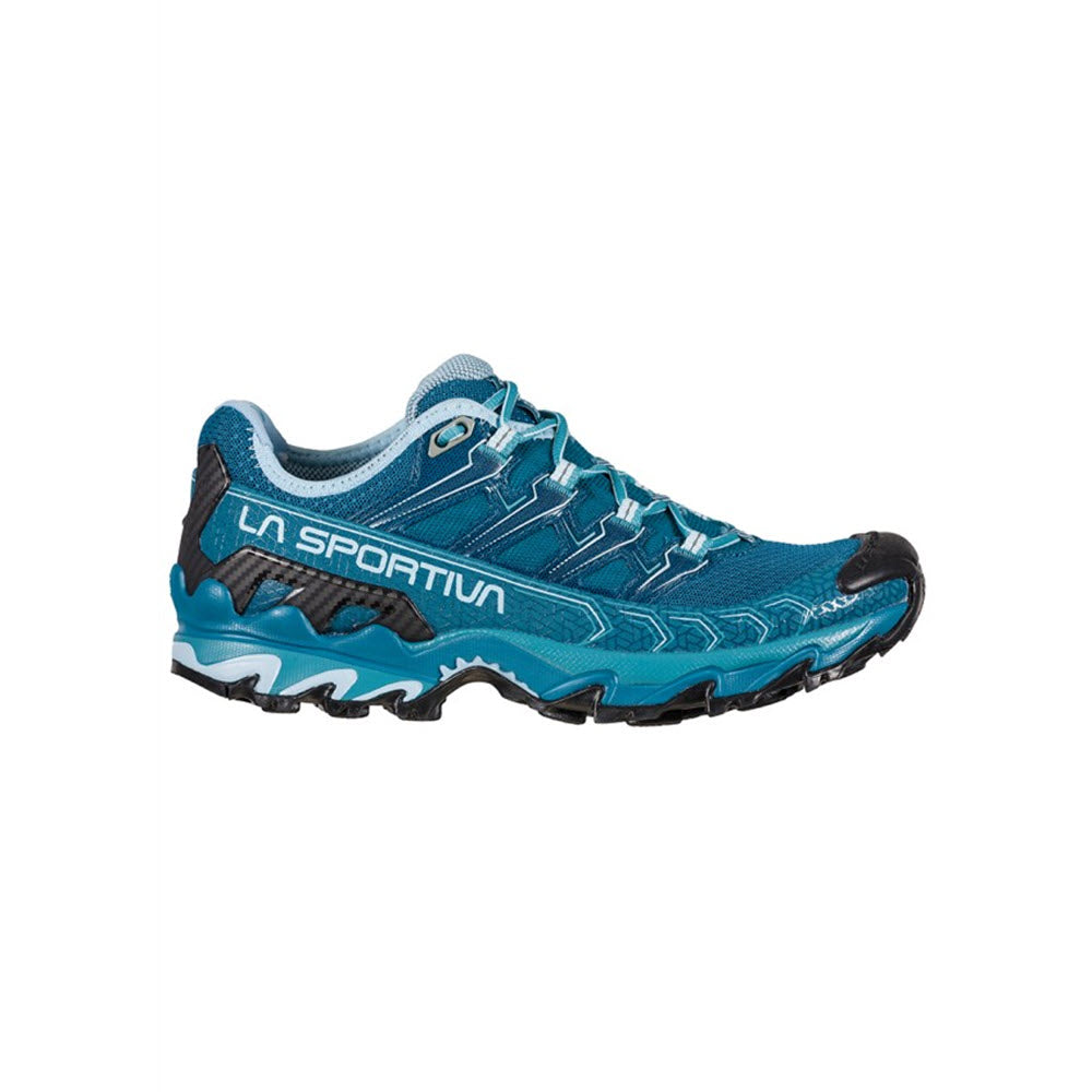 A blue La Sportiva Ultra Raptor II DENIM/ROGUE trail running shoe with black laces and distinctive grey sole tread isolated on a white background.