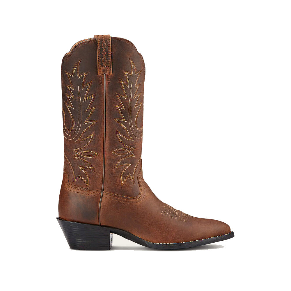 A single brown leather cowboy boot with decorative stitching, a pointed toe, and a mid-high heel combines modern comfort with a traditional look. Perfect for anyone seeking stylish cowgirl boots, the ARIAT HERITAGE WESTERN R TOE DISTRESSED BROWN - WOMENS from Ariat.