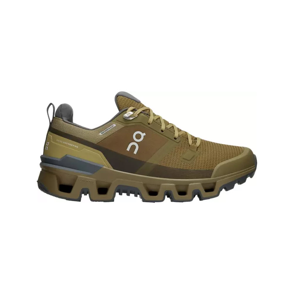 Profile view of a brown ON CLOUDWANDER WATERPROOF HUNTER/SAFARI - WOMENS hiking shoe with yellow laces, featuring a chunky, rugged sole and branded with a symbol on the side, designed as a lightweight outdoor performance shoe by On Running.