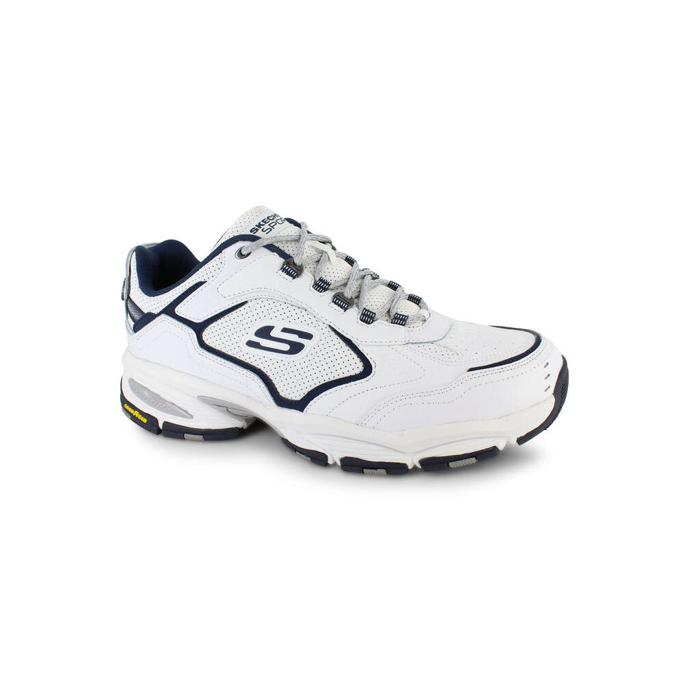 A white and navy Skechers Vigor 3.0 Arbiter athletic shoe with a prominent logo on the side features an Air-Cooled Memory Foam for enhanced comfort.
