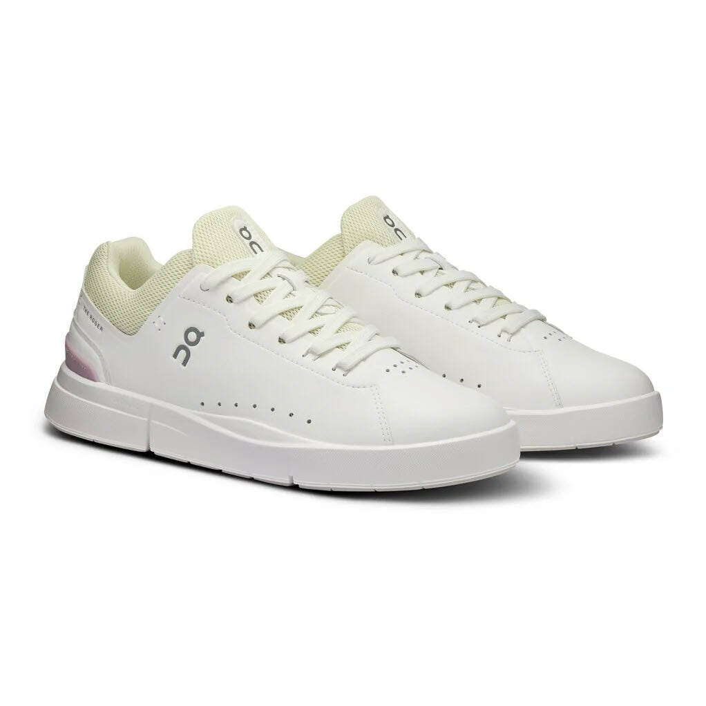 A pair of ON THE ROGER ADVANTAGE WHITE/MAUVE - WOMENS sneakers with CloudTec cushioning, displayed on a plain white background.