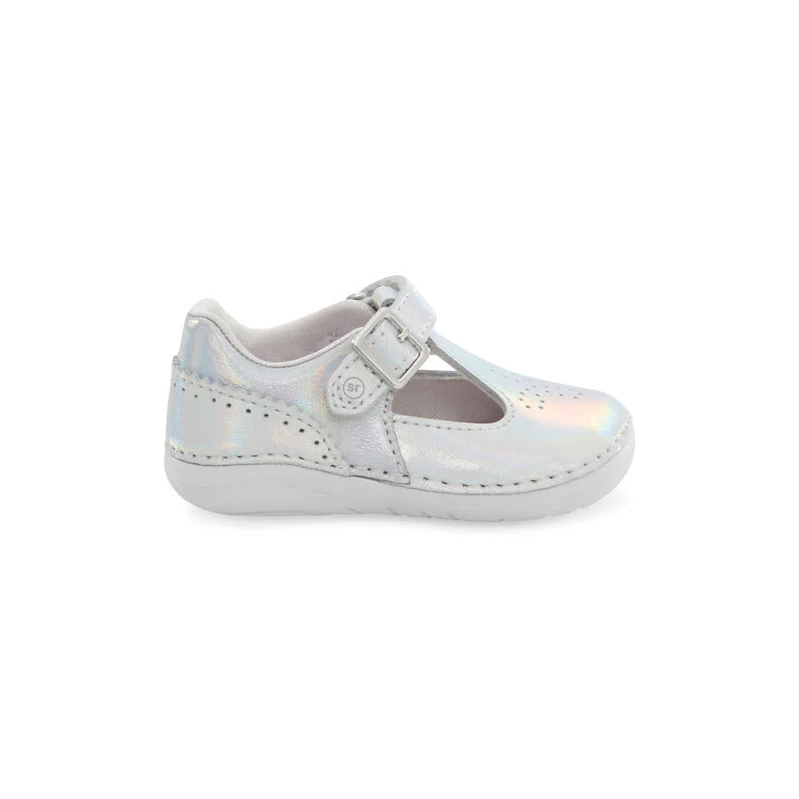 A single Stride Rite SM Lucianne Iridscent Children&#39;s shoe with a hook and loop closure, set against a white background.